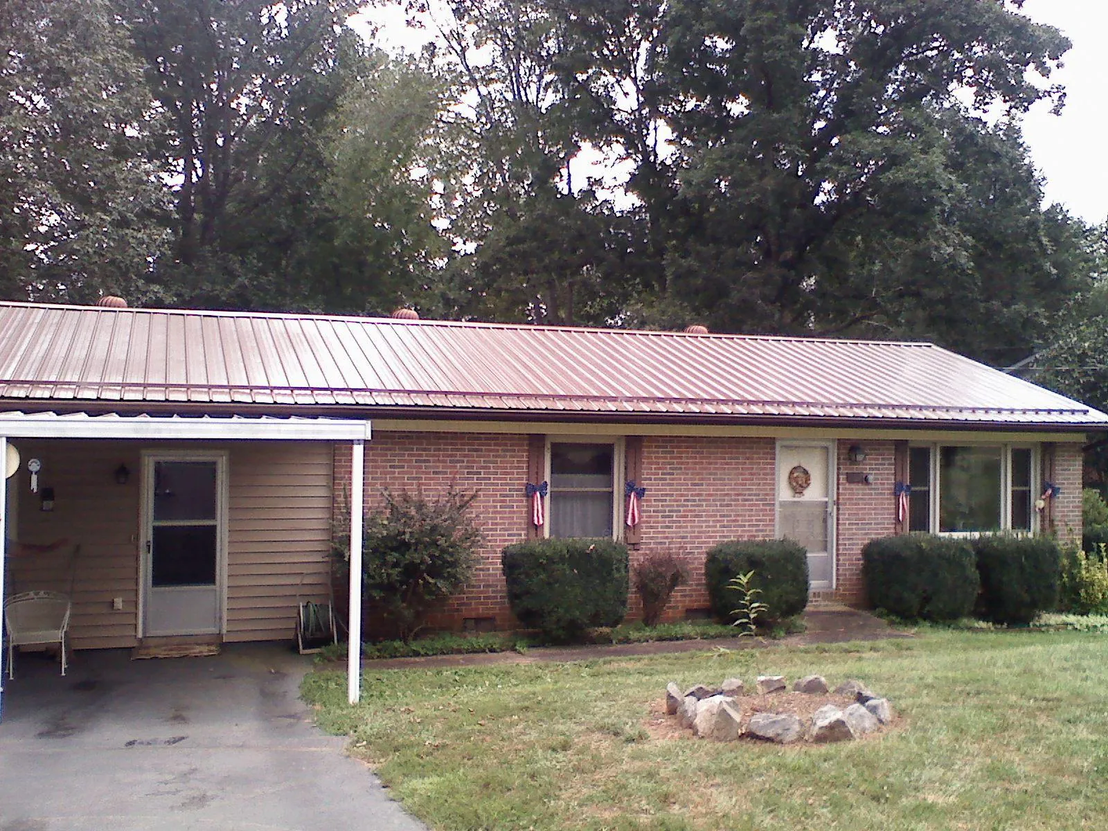 Bronze metal roof and carport on a brick ranch home — Roof Repair work by our crew in Fairview Heights