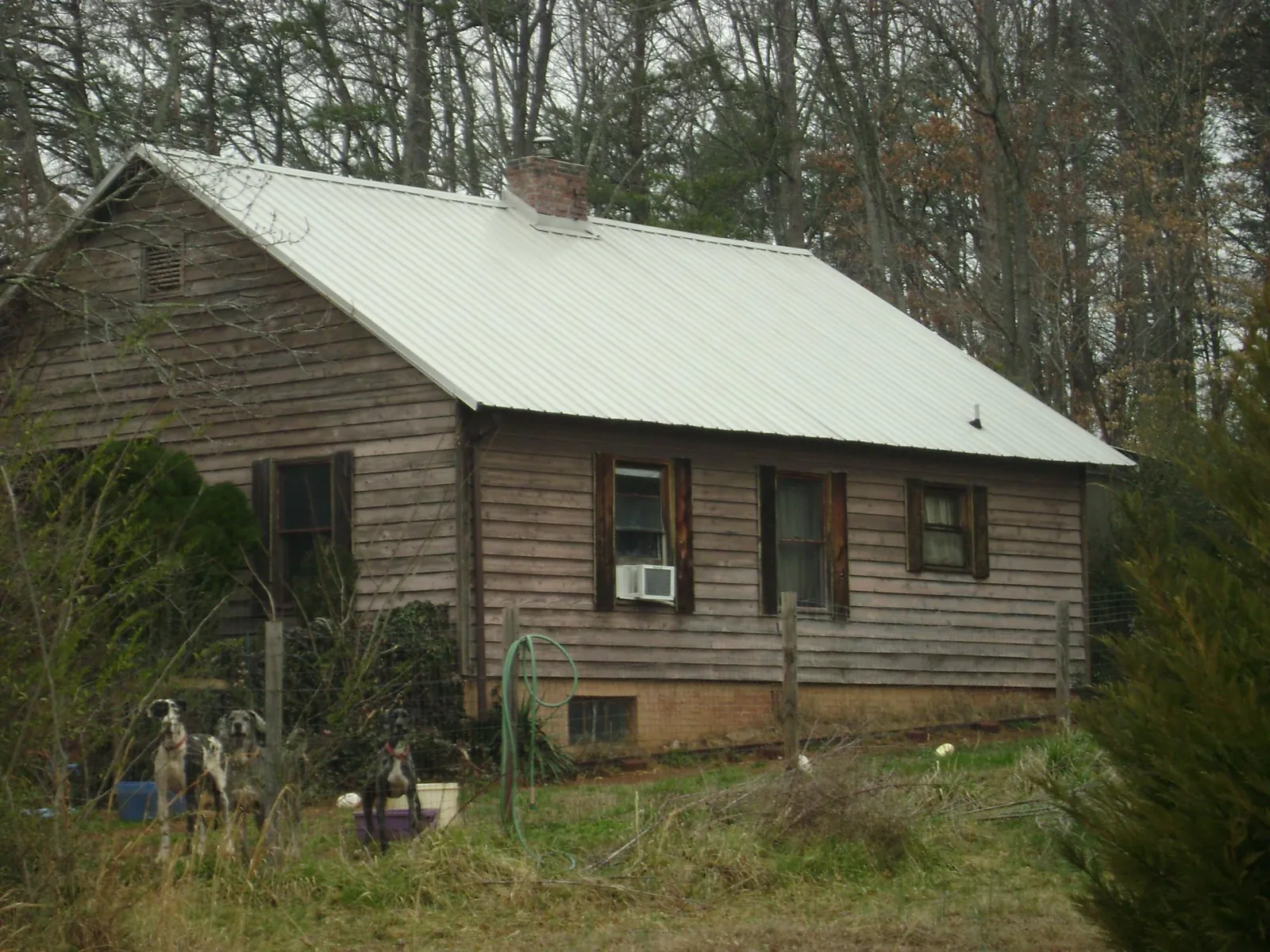 White metal roof on an old wood sided farmhouse, from a Metal Roof Installation job in Fairview Heights
